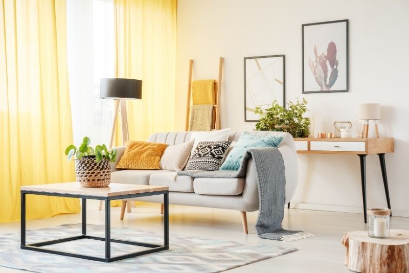 Sunlit family room with a coffee table and couch, recently cleaned by Cleaning Cairns staff