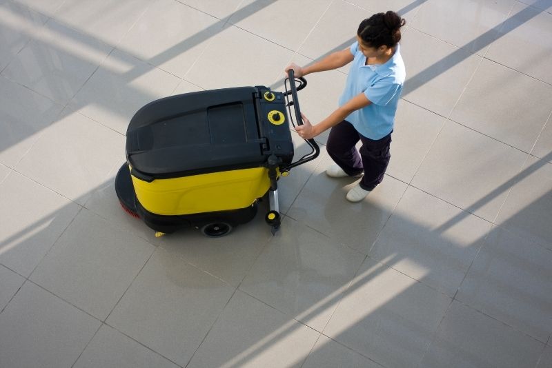 Cairns Cleaning staff using a floor cleaning machine in an office