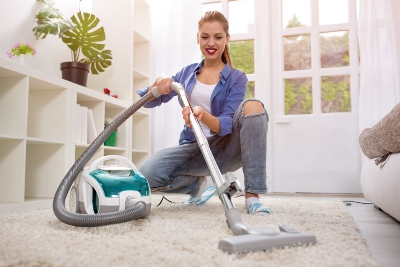 Cleaning Cairns staff vacuum a white rug