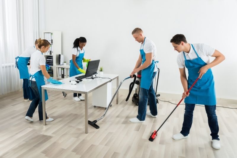 office cleaners Borthern Beaches wearing a blue apron