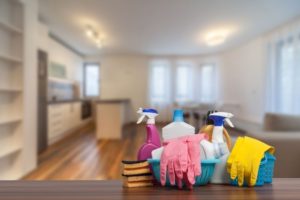 Basket of cleaning supplies and gloves on a table in a Port Douglas home
