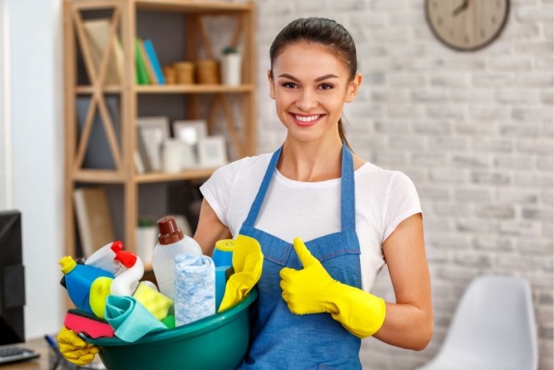 Cleaner with a bucket of supplies ready for an end of lease clean in Cairns Central